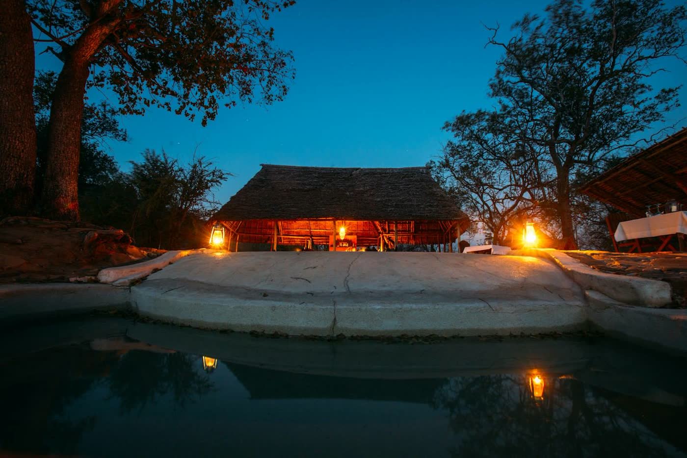 A safari camp setting at dusk in Tanzania